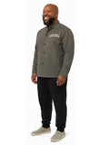 Adult wearing QUPPL weighted jacket in charcoal grey color showing 45 degree view.